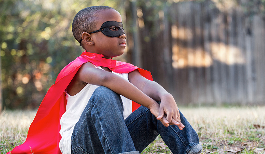 Boy with super hero mask and cape