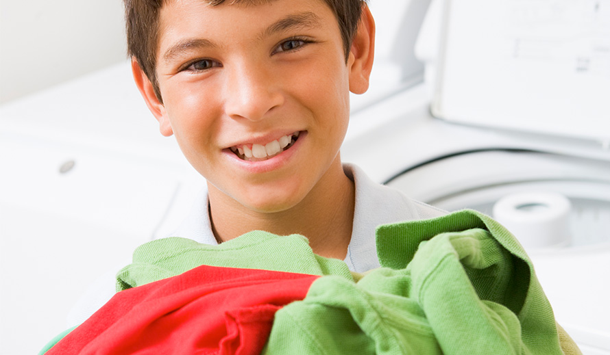 Boy helps with laundry duty