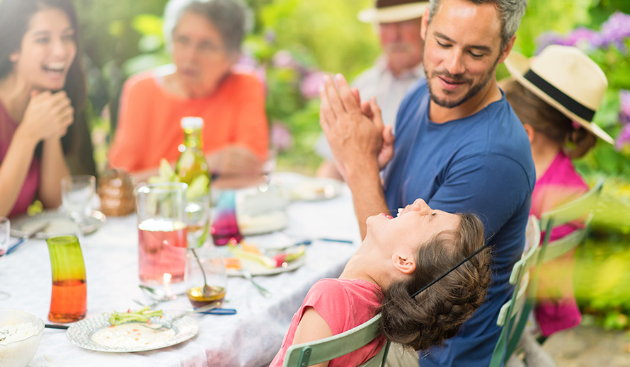 Happy mutigenerational family enjoying a meal.