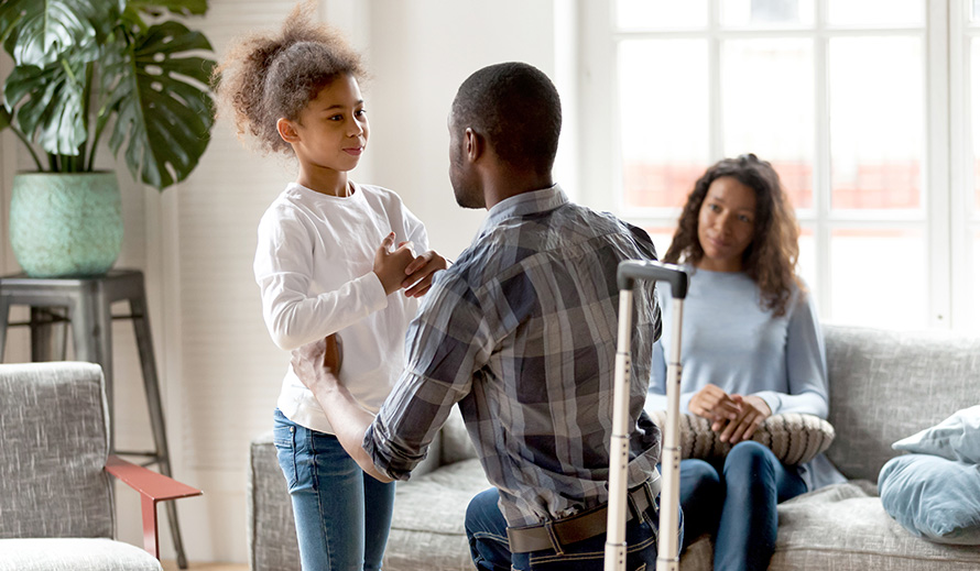 Departing father talks to his daughter while mother looks on.