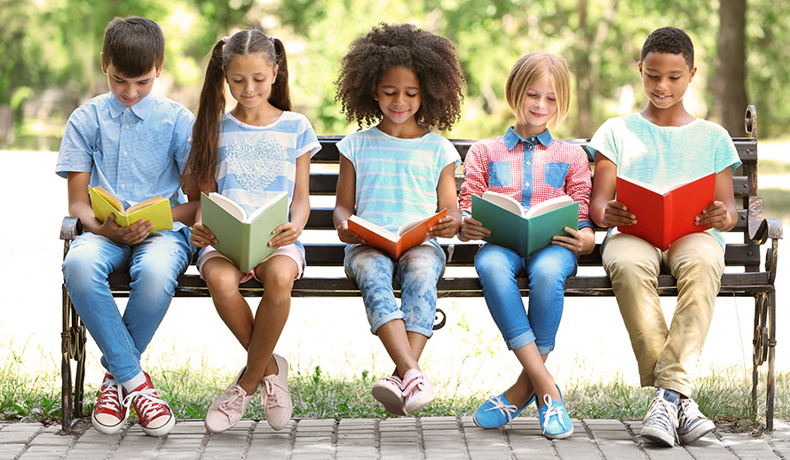 Middle-graders happily reading books.