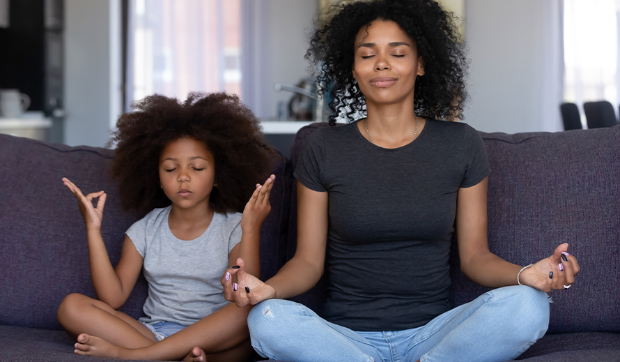 A mom and daughter practice yoga. 